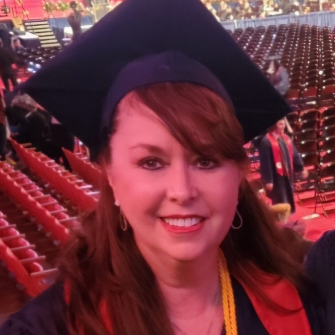 UIC RN to BSN alumna Sandra Ann Kline smiles in cap and gown